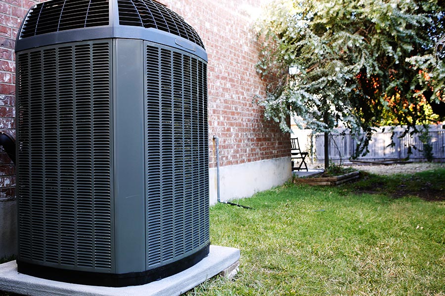 Well-maintained outdoor air conditioning system in backyard setting